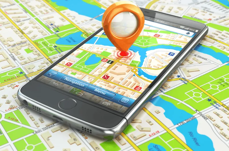 A smartphone displaying a digital map with a location pin, representing local search and Google Maps visibility.