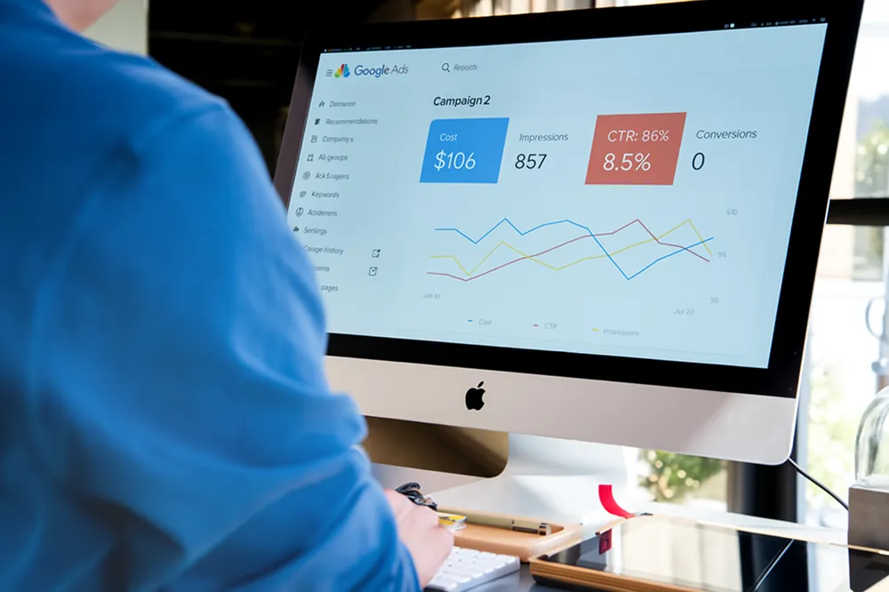 Person looking at a Google Ads dashboard on a computer screen showing high CTR and zero conversions, highlighting the challenge of ads getting clicks but not customers.